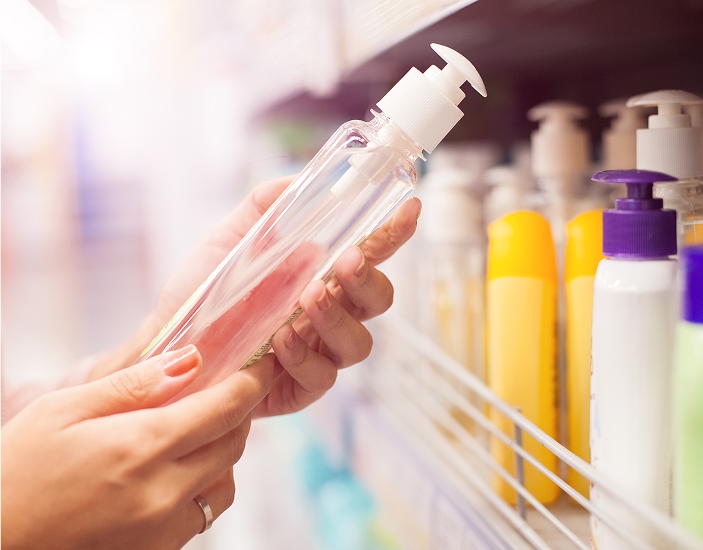 Photo of handsd holding a clear, plastic soap bottle